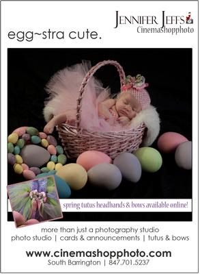 baby girl with pink tutu in easter basket with colored eggs